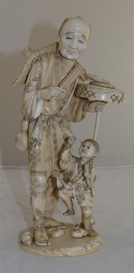 A large sectional ivory group of man and a boy, early 20th century, 30.5cm